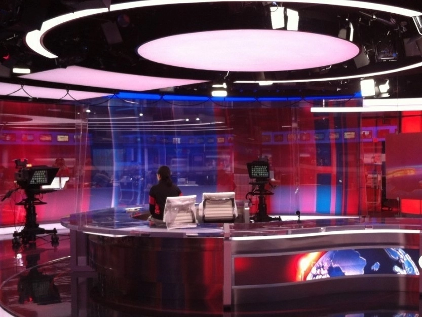 CCTV broadcast studio with teleprompters positioned around the anchor desk