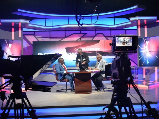 ZNBC television studio with teleprompters positioned around the broadcast set