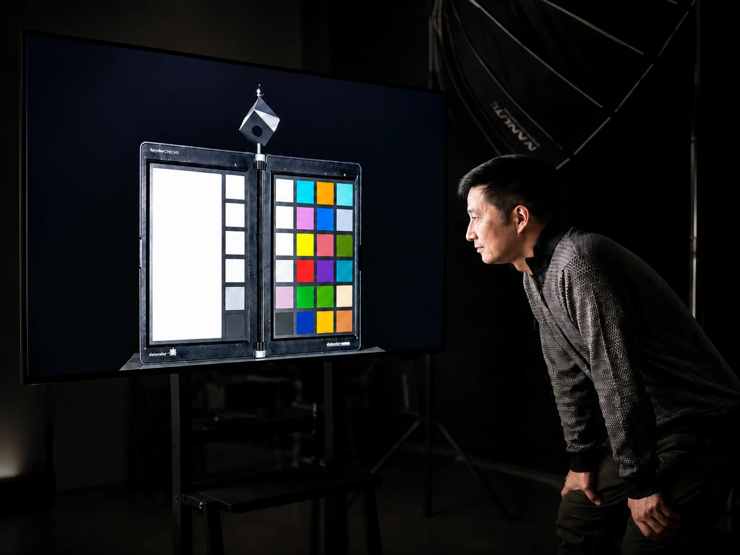 PROMPTERGO chief engineer inspecting display colour calibration in the studio